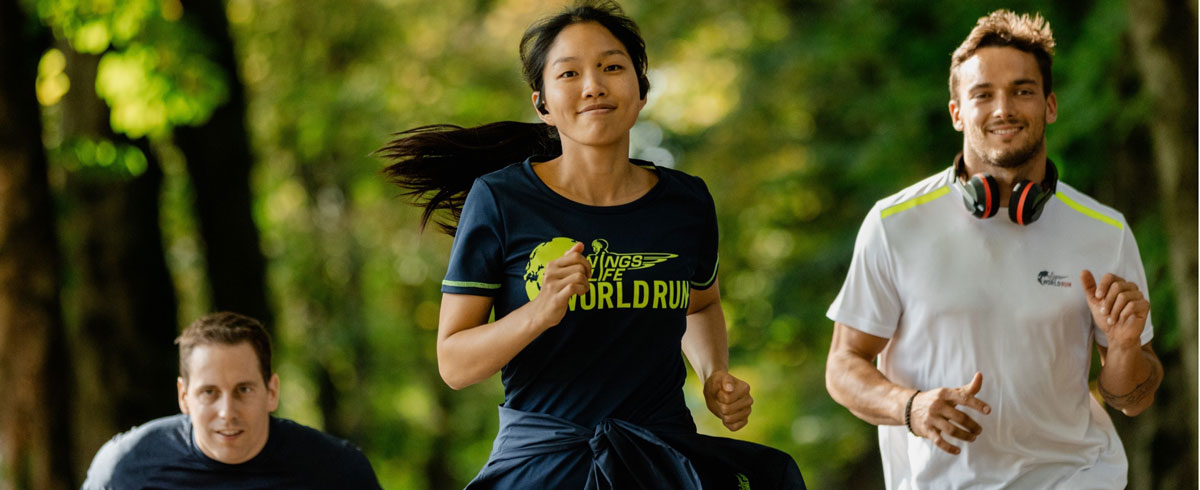 Três participantes da Wings for Life World Run a desfrutar da corrida com auscultadores desportivos da Philips.